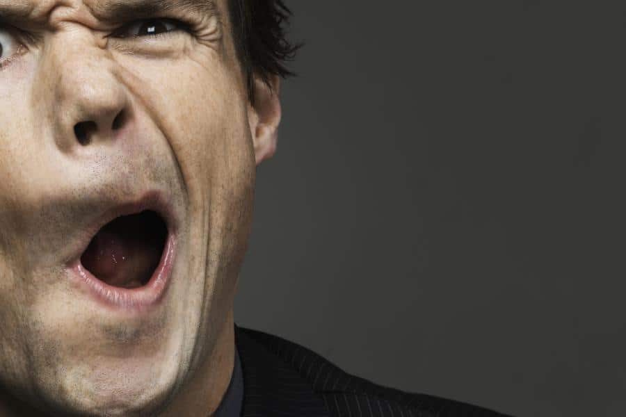 Portrait-of-businessman-pulling-a-funny