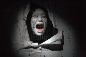 A ghost figure is pictured at a haunted house in Tokyo Dome City amusement park in Tokyo September 2, 2010. Other nations drink water or eat watermelons in summer, but the Japanese flock to "obake yashiki" or "haunted houses" to shiver, tremble and in this way cool down as the worst heatwave in history strikes the country. REUTERS/Antoni Slodkowski